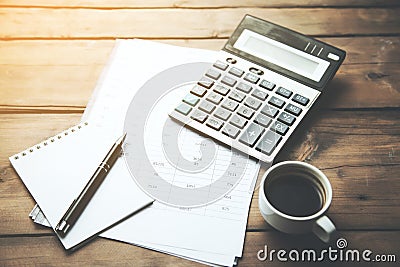 Calculator with cup of coffee on financial newspaper Stock Photo