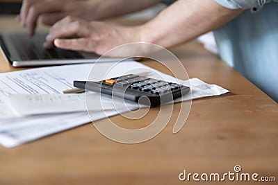 Calculator device lying on paper documents stack bills invoices notifications Stock Photo