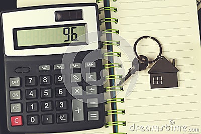 Calculator and key on notepad Stock Photo