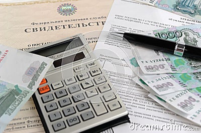 Calculator, money, pen and tax act against the background of the certificate Stock Photo