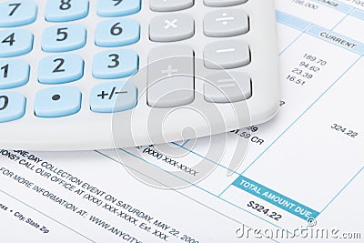 Calculator over utility bill Stock Photo
