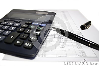 Calculator and pen on balance sheet Stock Photo