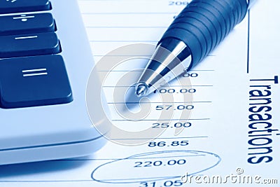 Calculator and Pen on Financial Statement Stock Photo