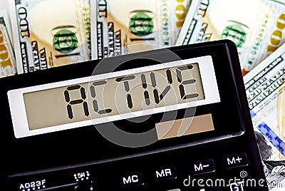 Calculator with text ACTIVE on the dollars. Business, finance conceptual Stock Photo