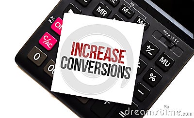 calculator with text increase conversions with white paper Stock Photo