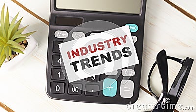 calculator with text INDUSTRY TRENDS with Stock Photo