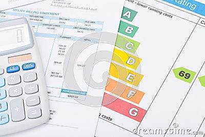 Calculator with utility bill and energy rating chart Stock Photo