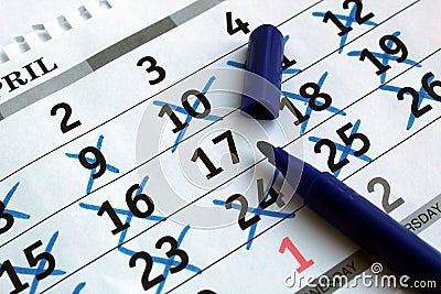 On the table is a calendar sheet with the date marked Stock Photo