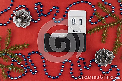 Calendar with the date January 01 on a Christmas red background. festive decorations and fir branches with cones Stock Photo