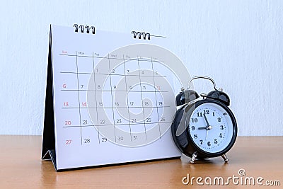 Calendar With Days and clock on wood table Stock Photo