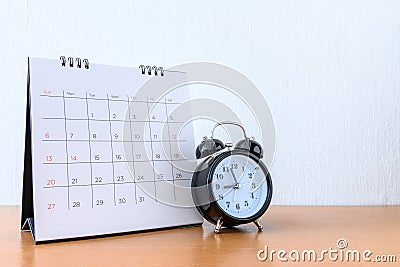 Calendar With Days and clock on wood table Stock Photo