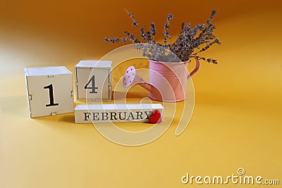 Calendar for February 14: lavender bouquet in a pink watering can, red heart, numbers one and four, name of the month in English, Stock Photo