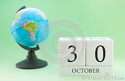 Calendar made of wood on a light green background, 30 day of the month October, autumn 30th day Stock Photo