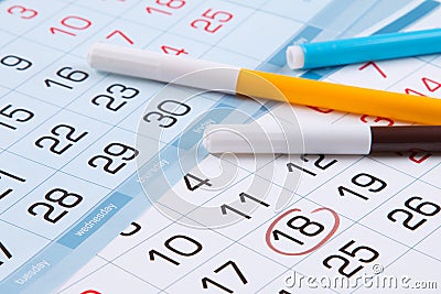 Calendar with a mark of a specific day and colored markers Stock Photo