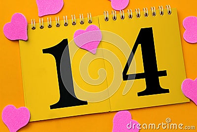 Calendar with number 14 on a yellow background with pink hearts mess on bright yellow background Stock Photo