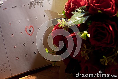 Calendar page with a red hand written heart highlight on February 14 Stock Photo