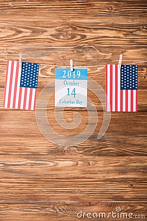 Calendar paper sheet with 14 October date between American national flags Stock Photo