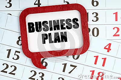 On the calendar, a red plaque with the words inside - Business plan Stock Photo