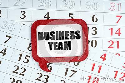 On the calendar, a red plaque with the words inside - Business team Stock Photo