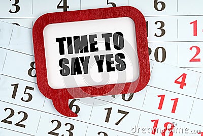 On the calendar, a red plaque with the words inside - TIME TO SAY YES Stock Photo