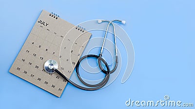 Calendar, stethoscope, on a blue background, health care concept. Stock Photo