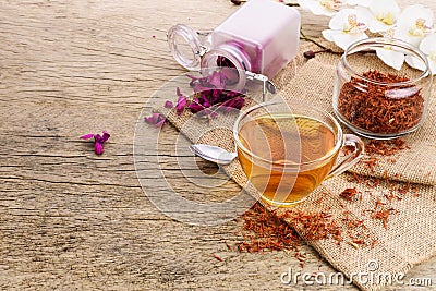Calendula teacup With dried marigold flowers scattered on an old wooden table with copy space for your text - Top view Stock Photo