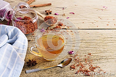 Calendula teacup With dried marigold flowers scattered on an old wooden table with copy space for your text - Top view Stock Photo