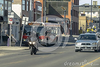 A biker in the city traffic. Concept: Motorcycle season Editorial Stock Photo