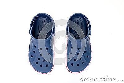 Top view of a couple of blue Crocs Sandals on a white table Editorial Stock Photo