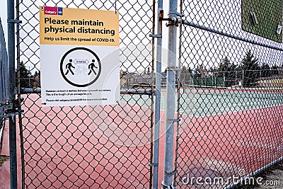 A Covid-19 safe distancing sign at tennis courts in the community of Scenic Acres during a Editorial Stock Photo