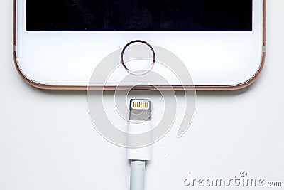 Close up of an iPhone Plus and a Lightning to USB Cable. Apple is killing Lightning Editorial Stock Photo