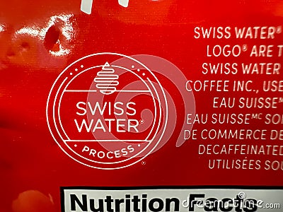 A close up to a Swiss Water Process logo from a Tim Hortons Decaf Coffee package Editorial Stock Photo