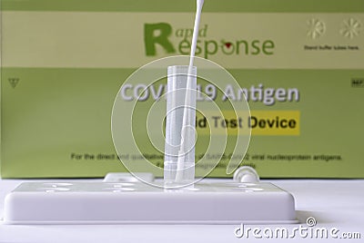 A Rapid Response rapid rest kit in the process of testing for Covid 19 at home. Editorial Stock Photo