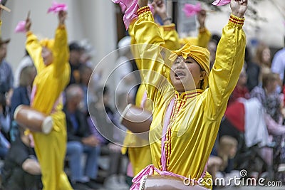 A Chinese person dancing at a public parade with a traditional cloths. Editorial Stock Photo