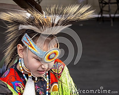 A medium shot of a indigenous kid talent showcase wearing a yellow traditional cloths Editorial Stock Photo