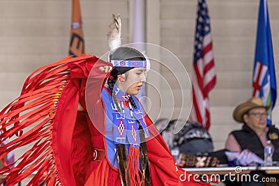 A medium shot of an indigenous woman talent showcase wearing a red traditional dress. Editorial Stock Photo