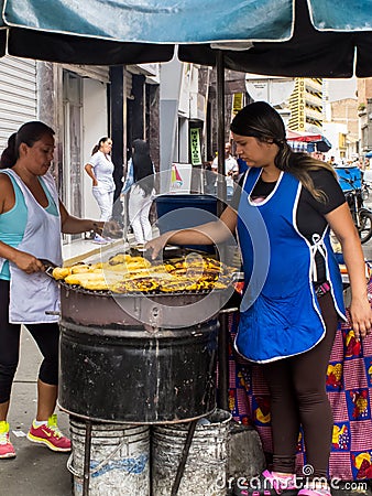 Women cooking and selling roasted ripe plantain at Cali city center Editorial Stock Photo