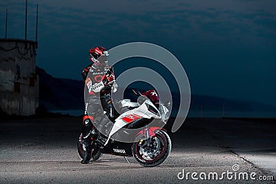 15.10.20 California, USA. The driver in a motorcycle outfit is sitting on a sport bike. Night. Outdoor Editorial Stock Photo