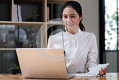Call center agent with headset working on support hotline in office. Video conference Stock Photo