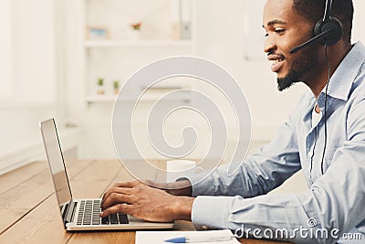 Call center operator man with headset working Stock Photo