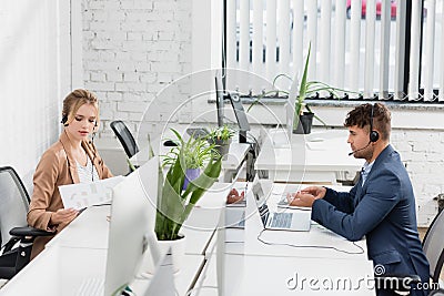 Call center operators in headsets working Stock Photo