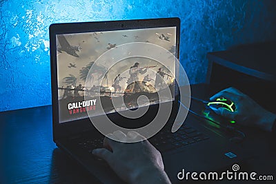 Call of Duty: Vanguard is first-person shooter video game. Man playing video game on laptop Editorial Stock Photo