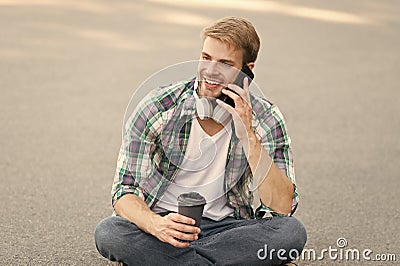 Call friend. Wellbeing and health. Having coffee break. Man sit on ground while drinking coffee. Relax and recharge Stock Photo