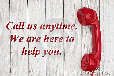 Call us anytime we are here to help text with retro red phone handset Stock Photo
