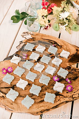 Calligraphed place cards for dinner arrranged on a wooden plank Stock Photo