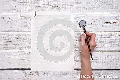 Calligraphy sheets, nibs, paper, ink on a wooden background. empty copybook. top view, flat lay. Stock Photo