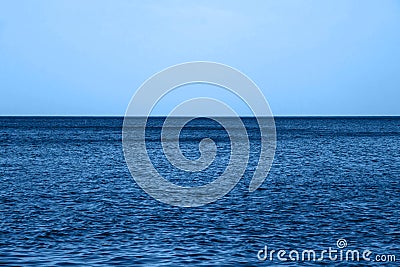 Calm Blue sea waves soft surface Ocean And Blue Sky in classic blue trendy color. background. Color of the year 2020 Stock Photo