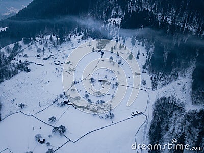 Calm and cosy fairy-tale village Kryvorivnia covered with snow in the Carpathians mountains, aerial view. Typical landscape in Stock Photo