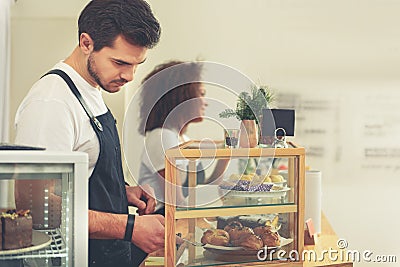 Calm counterman preparing wish of client Stock Photo