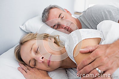 Calm couple sleeping and spooning in bed Stock Photo